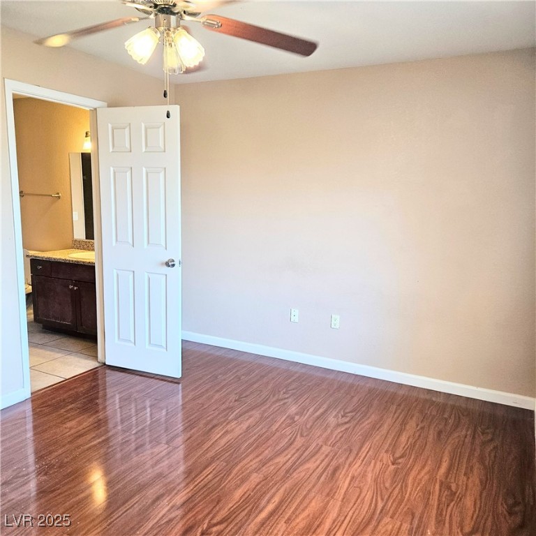 2120 Ramrod Avenue, Unit 1226 Henderson, NV 89014 - Photo 31 of 53 Unfurnished bedroom featuring light wood-style floors, ensuite bath, and a ceiling fan
