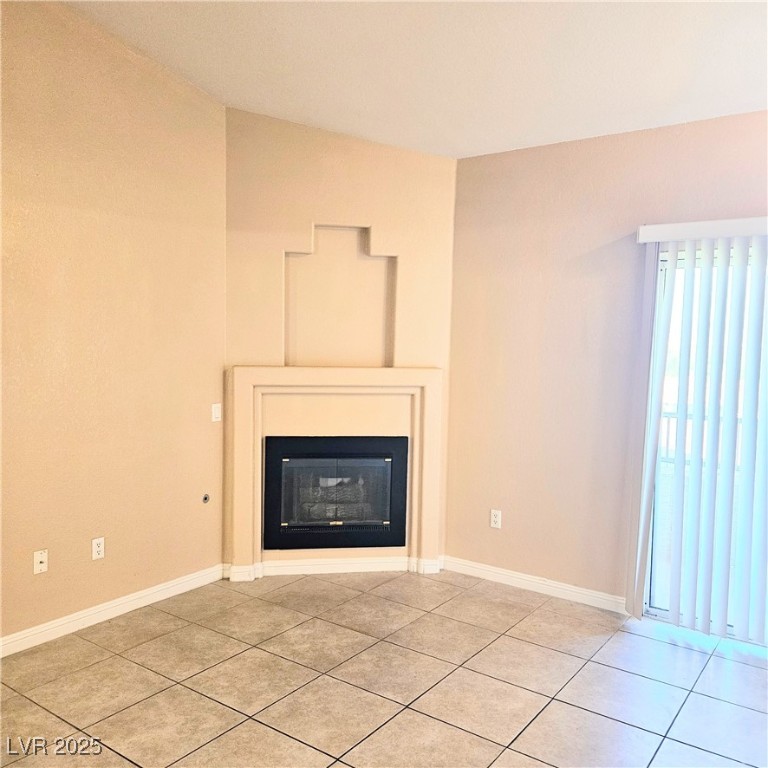 2120 Ramrod Avenue, Unit 1226 Henderson, NV 89014 - Photo 10 of 53 Detailed view of a glass covered fireplace and baseboards