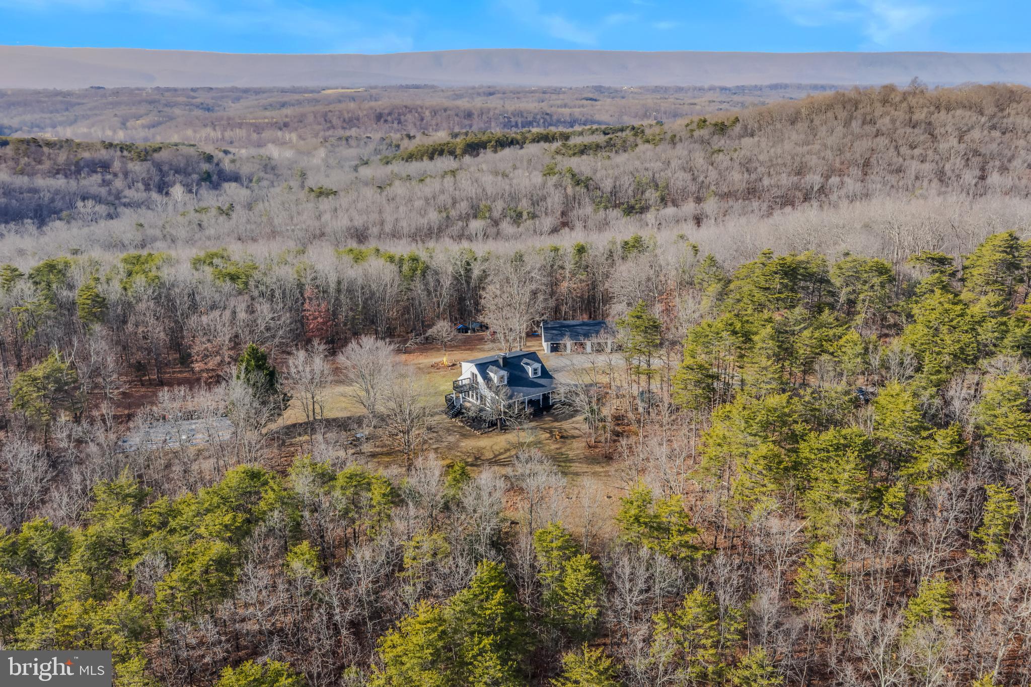 654 Soper Lane Berkeley Springs, WV 25411 - Photo 2 of 71 a view of a dry field with trees