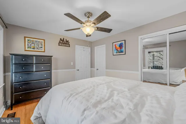 a bedroom with a large bed and a large mirror