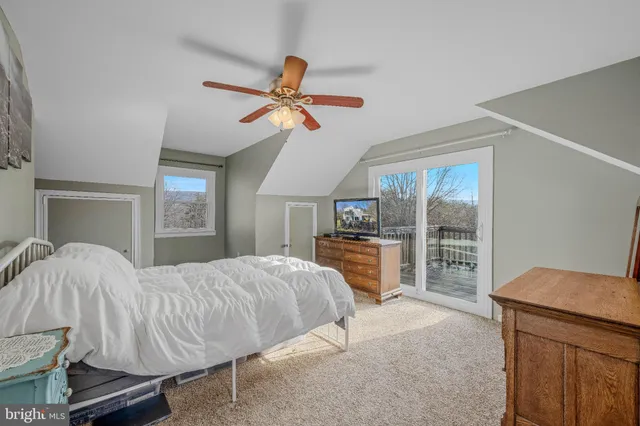 a view of a yard with wooden fence