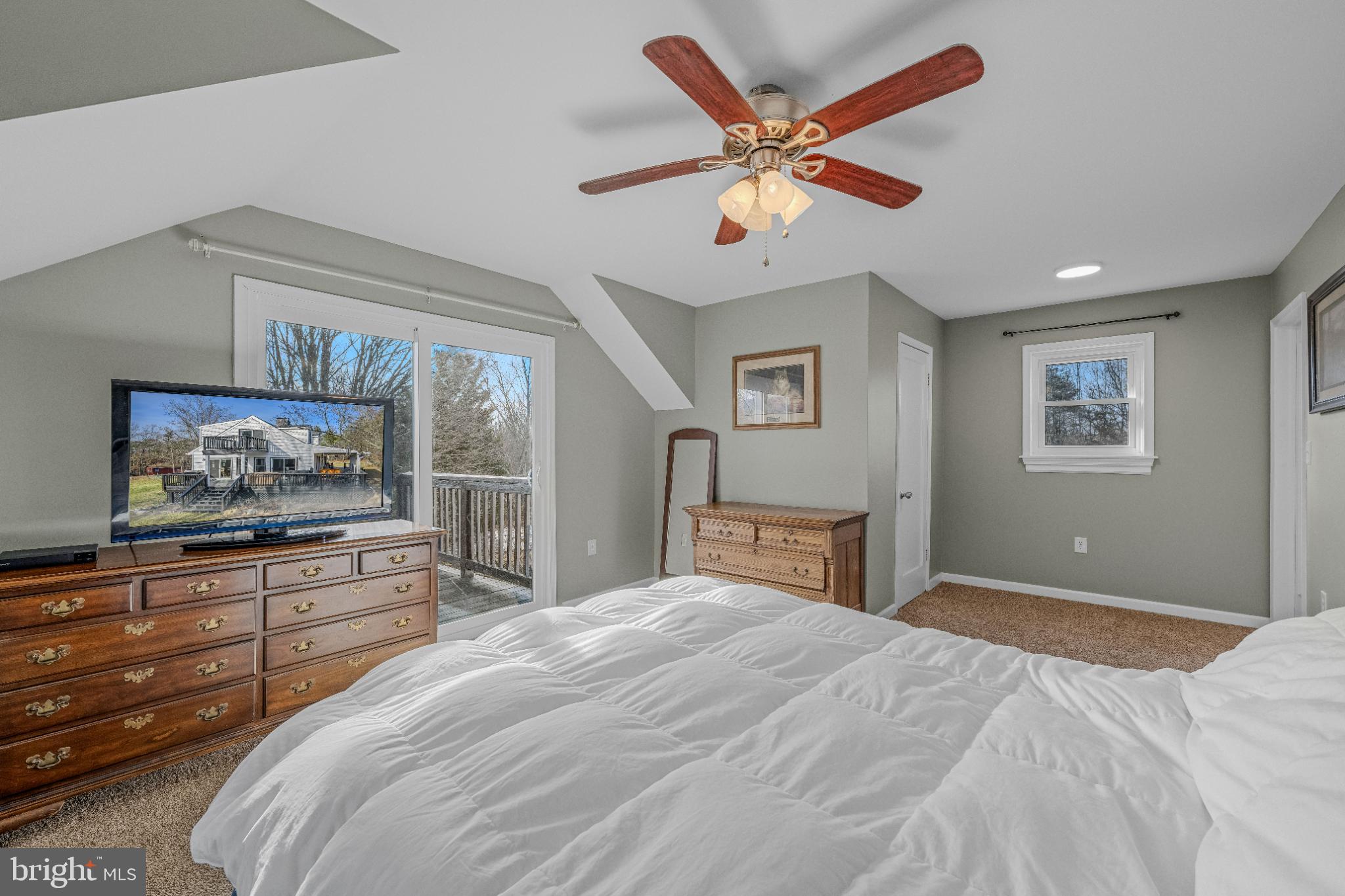 654 Soper Lane Berkeley Springs, WV 25411 - Photo 28 of 71 a bedroom with a large bed and a large mirror
