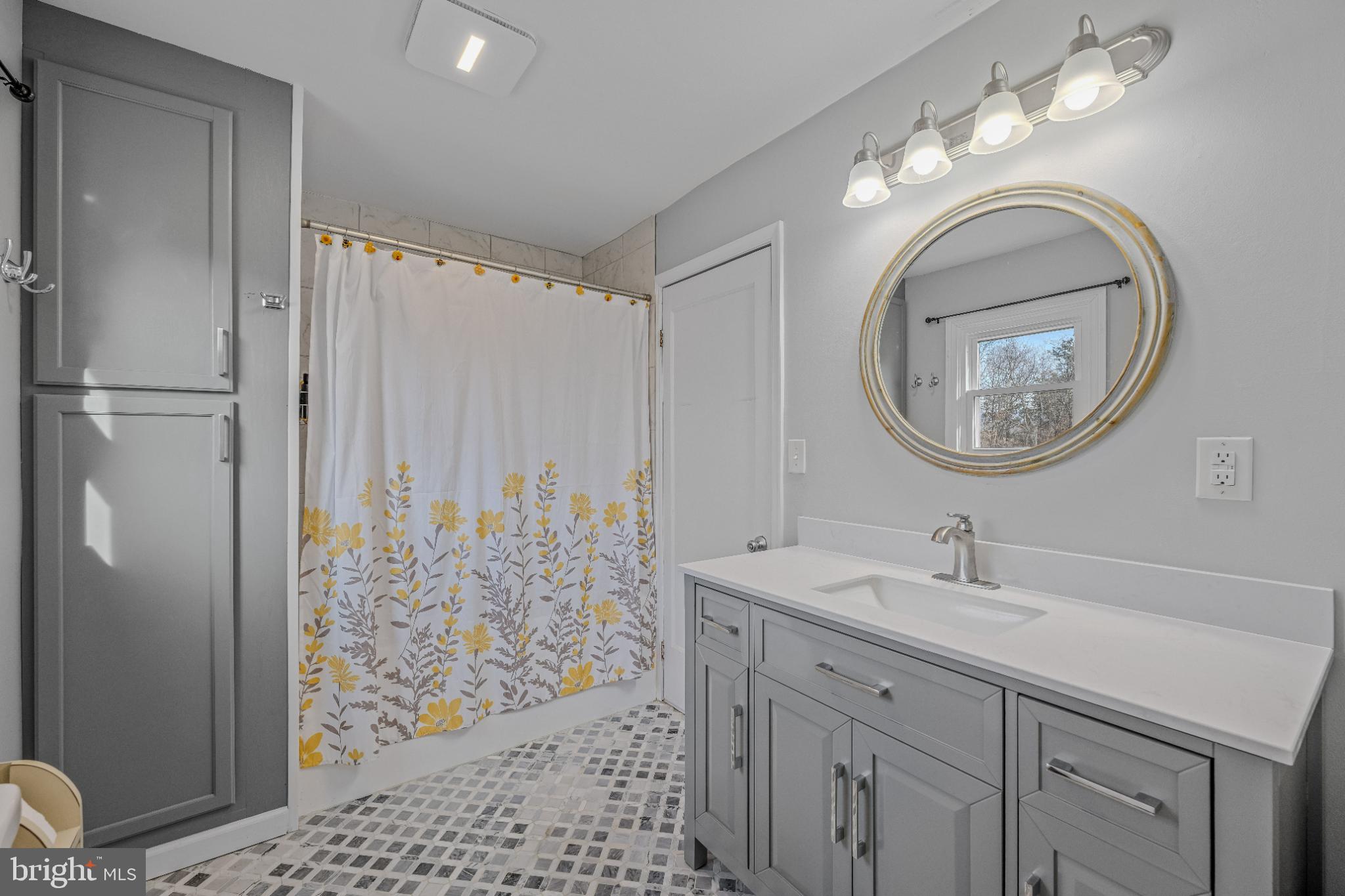 654 Soper Lane Berkeley Springs, WV 25411 - Photo 29 of 71 a bathroom with a sink a mirror a vanity and a shower