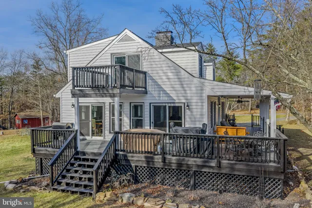 a view of a house with wooden fence