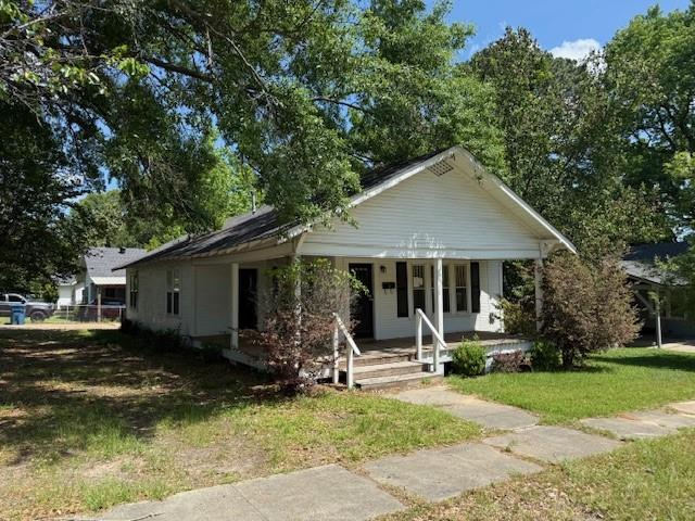 115 Goode Avenue Minden, LA 71055 - Photo 2 of 12 a front view of a house with garden