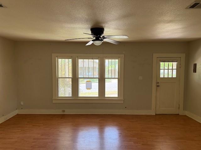 115 Goode Avenue Minden, LA 71055 - Photo 3 of 12 a view of an empty room with a window and wooden floor