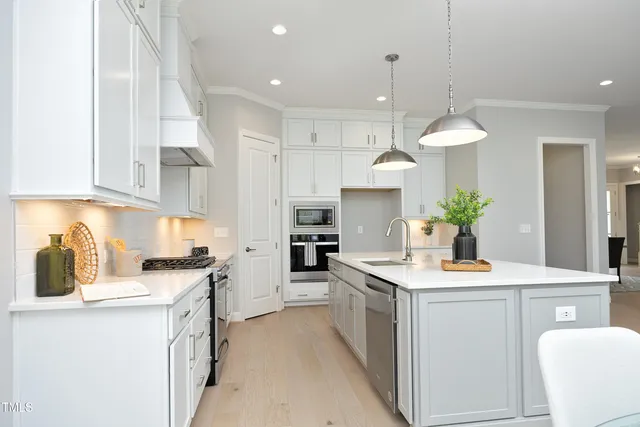 a kitchen with a sink stove and cabinets