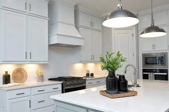 a kitchen with a stove and a white cabinets