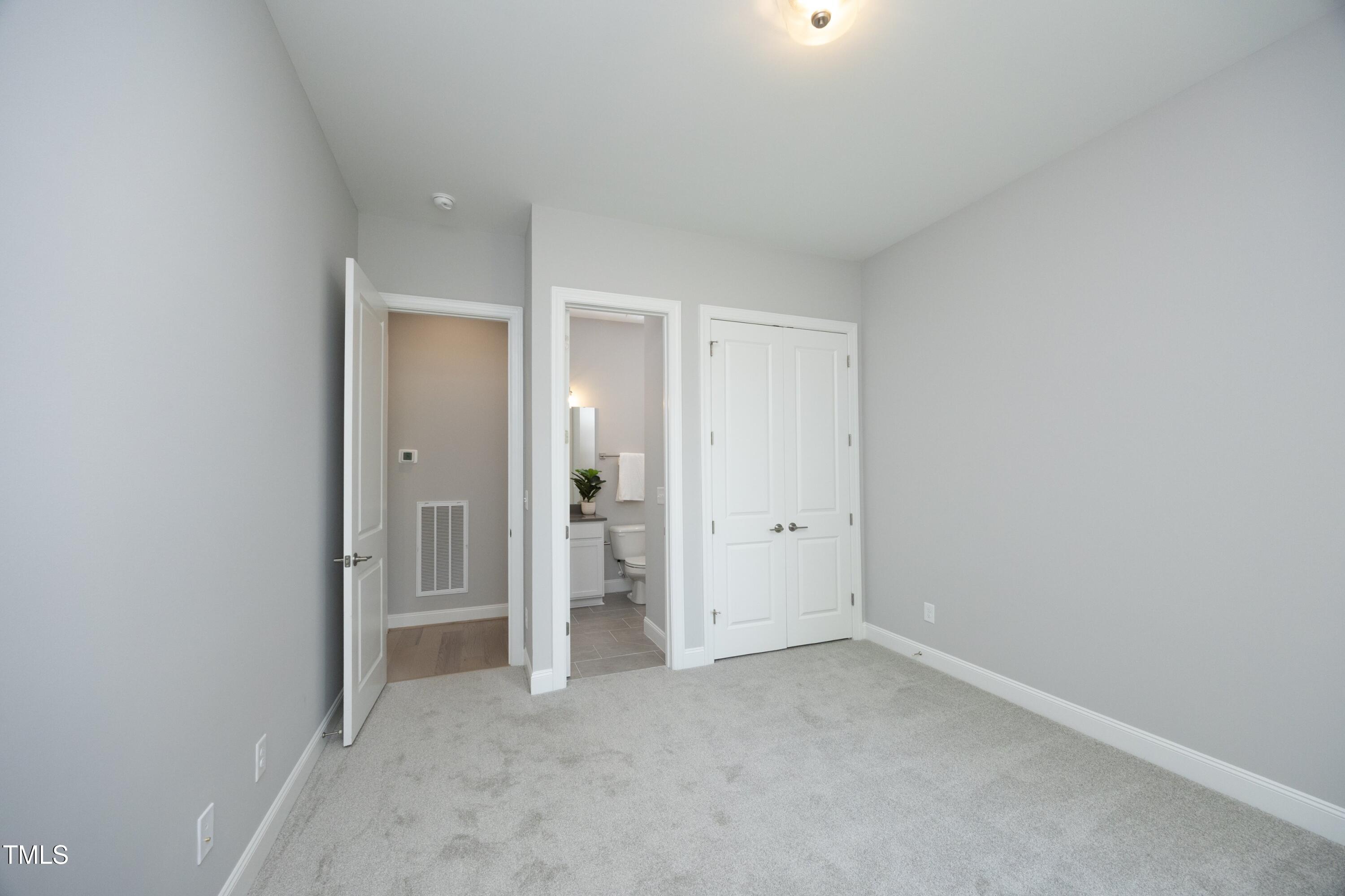 812 Willow Tower Court Rolesville, NC 27571 - Photo 21 of 43 an empty room with closet and a bathroom