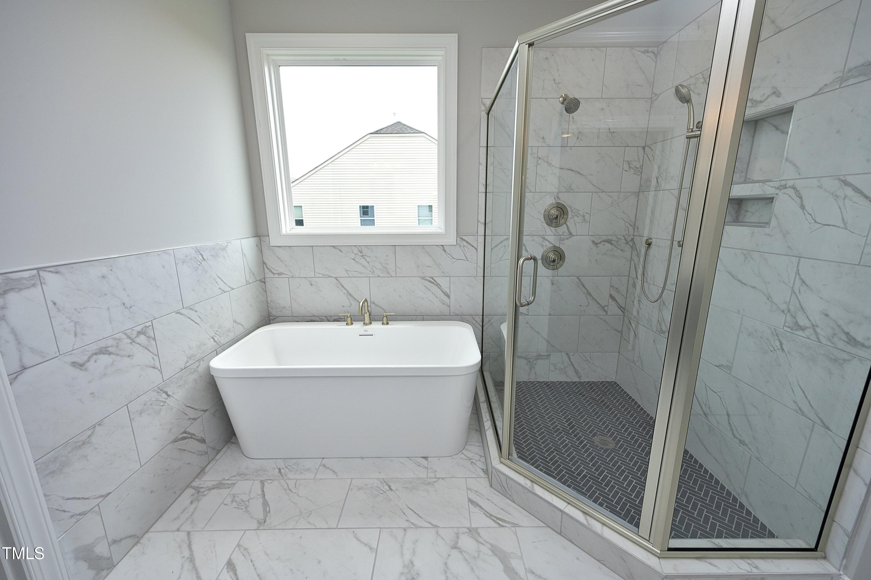 812 Willow Tower Court Rolesville, NC 27571 - Photo 27 of 43 a bathroom with a bathtub and shower