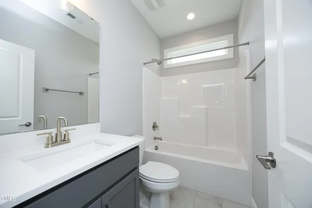 a view of a room with wooden floor and windows