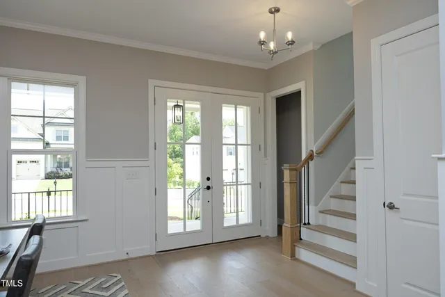 a view of entryway with wooden floor and livingroom view