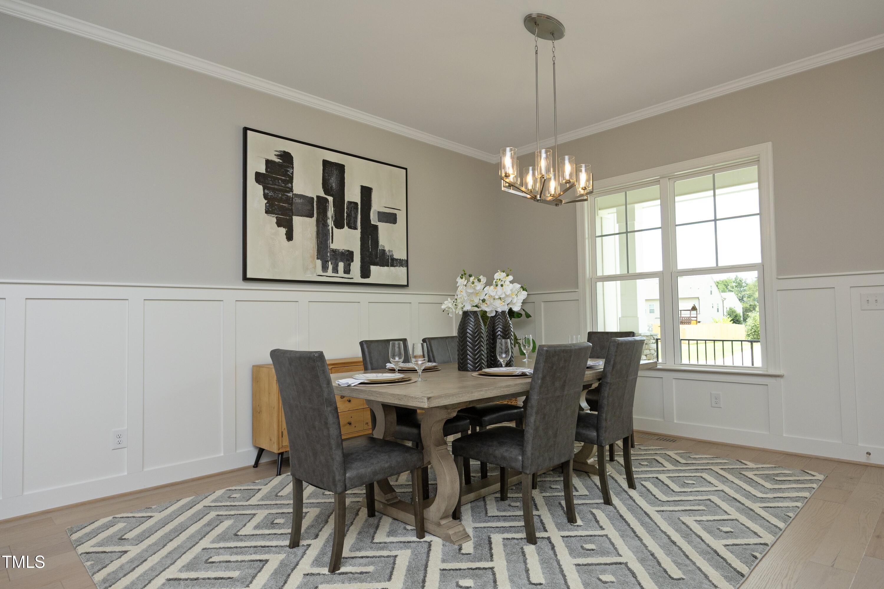 812 Willow Tower Court Rolesville, NC 27571 - Photo 5 of 43 a dining room with furniture a chandelier and wooden floor
