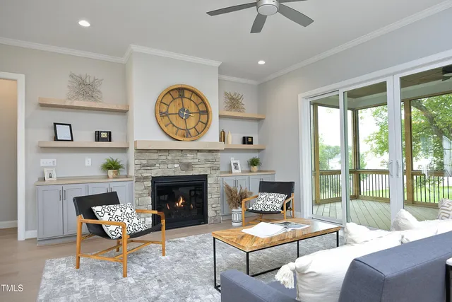 a living room with furniture a fireplace and a large window