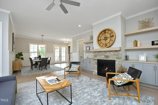 a living room with furniture a clock and a fireplace