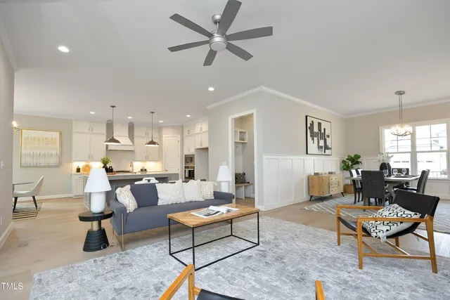 a living room with furniture a rug and a chandelier