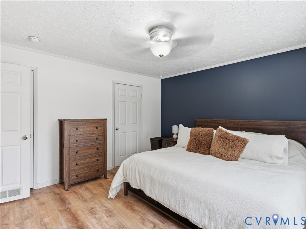 13520 Dykeland Road Amelia Court House, VA 23002 - Photo 13 of 33 a bedroom with a bed and a chandelier