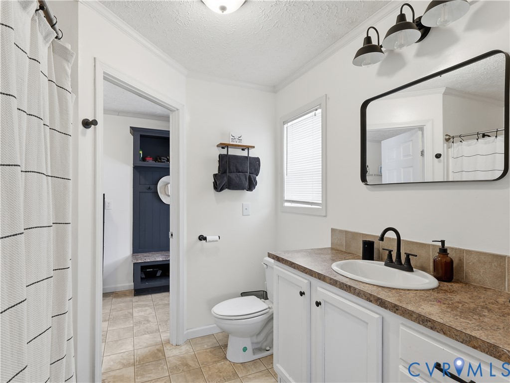 13520 Dykeland Road Amelia Court House, VA 23002 - Photo 14 of 33 a bathroom with a granite countertop sink toilet and shower