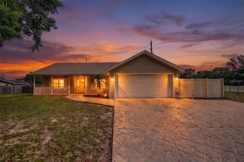 a view of a house with a yard and garage