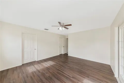 a view of a room with wooden floor and white walls