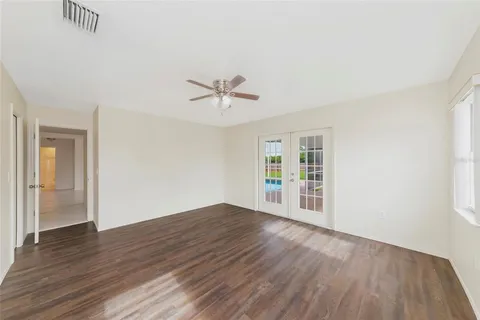 wooden floor in an empty room with a window