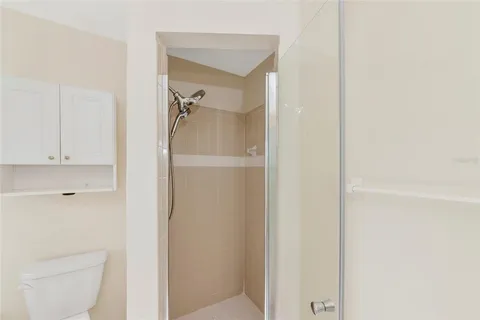 a bathroom with a shower a toilet and a sink