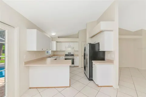 a kitchen with a sink a counter top space and appliances
