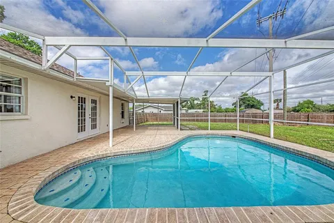 a view of a backyard with a swimming pool