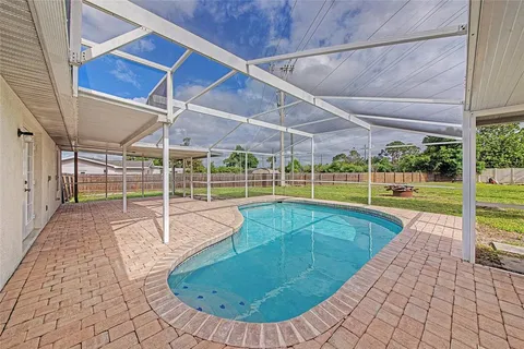 a view of a backyard with a swimming pool