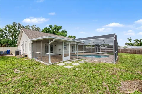 a view of a house with a yard and sitting area