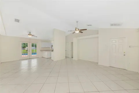 an empty room with a white walls and chandelier