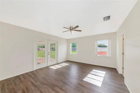 wooden floor in an empty room with a window