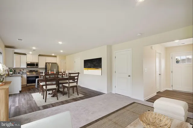 a kitchen with stainless steel appliances granite countertop a sink refrigerator and window