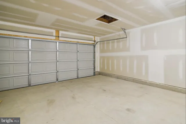 a view of a room with wooden floor and white walls