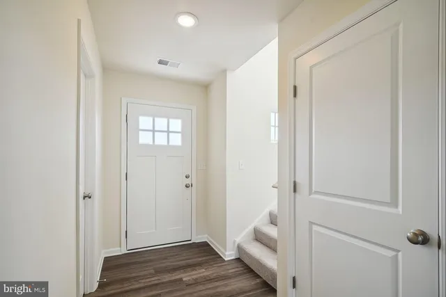 a living room with stainless steel appliances furniture a table and chairs
