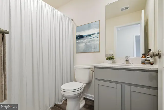 a bathroom with a sink a toilet and mirror