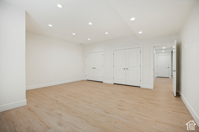 259 Twin River Loop Alpine, UT 84004 - Photo 37 of 61 Bedroom 2 showing the double closets, recessed ceiling lighting, light wood-finish flooring, white walls, white bi-fold doors, and a white interior doors.