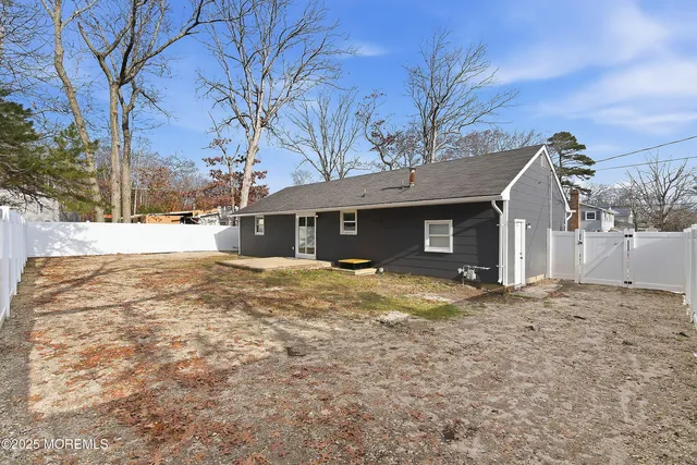 a view of a house with a yard covered in snow