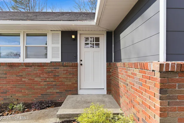 a view of front door of house with stairs
