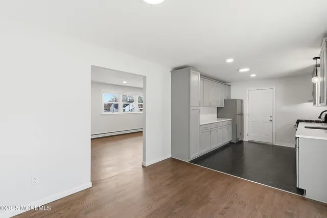 a view of a kitchen with a sink and a refrigerator