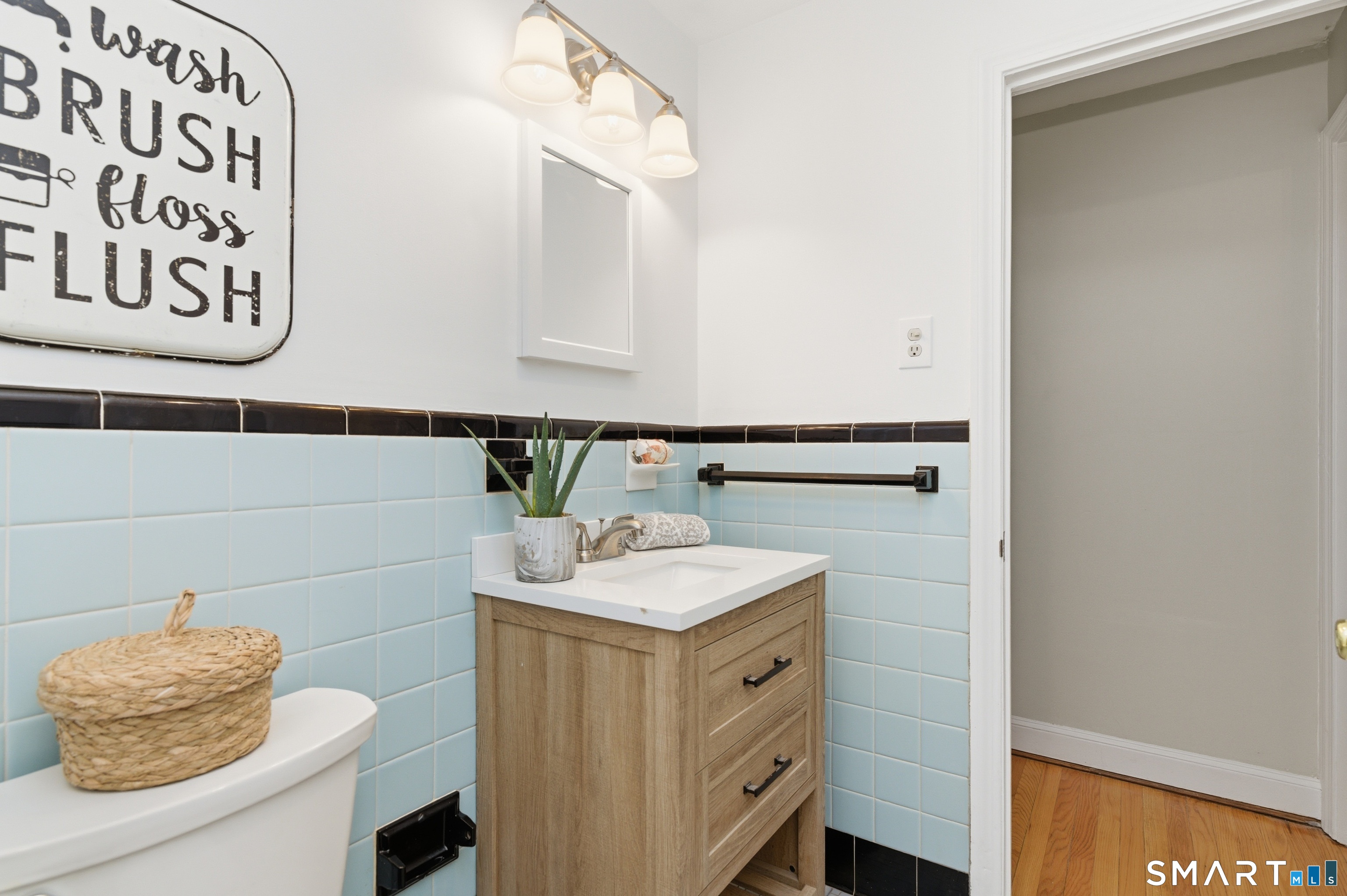 149 Mill Street Wethersfield, CT 06109 - Photo 15 of 29 a bathroom with a sink and a mirror