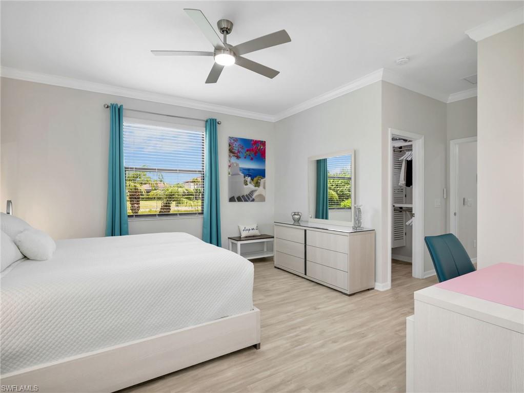 4383 Bismark Way Naples, FL 34119 - Photo 16 of 49 Primary Bedroom with Crown Molding, Pergo Laminate Flooring, Brand New Ceiling Fan, & 2 Large Walk-In Closets with Closet Organizers