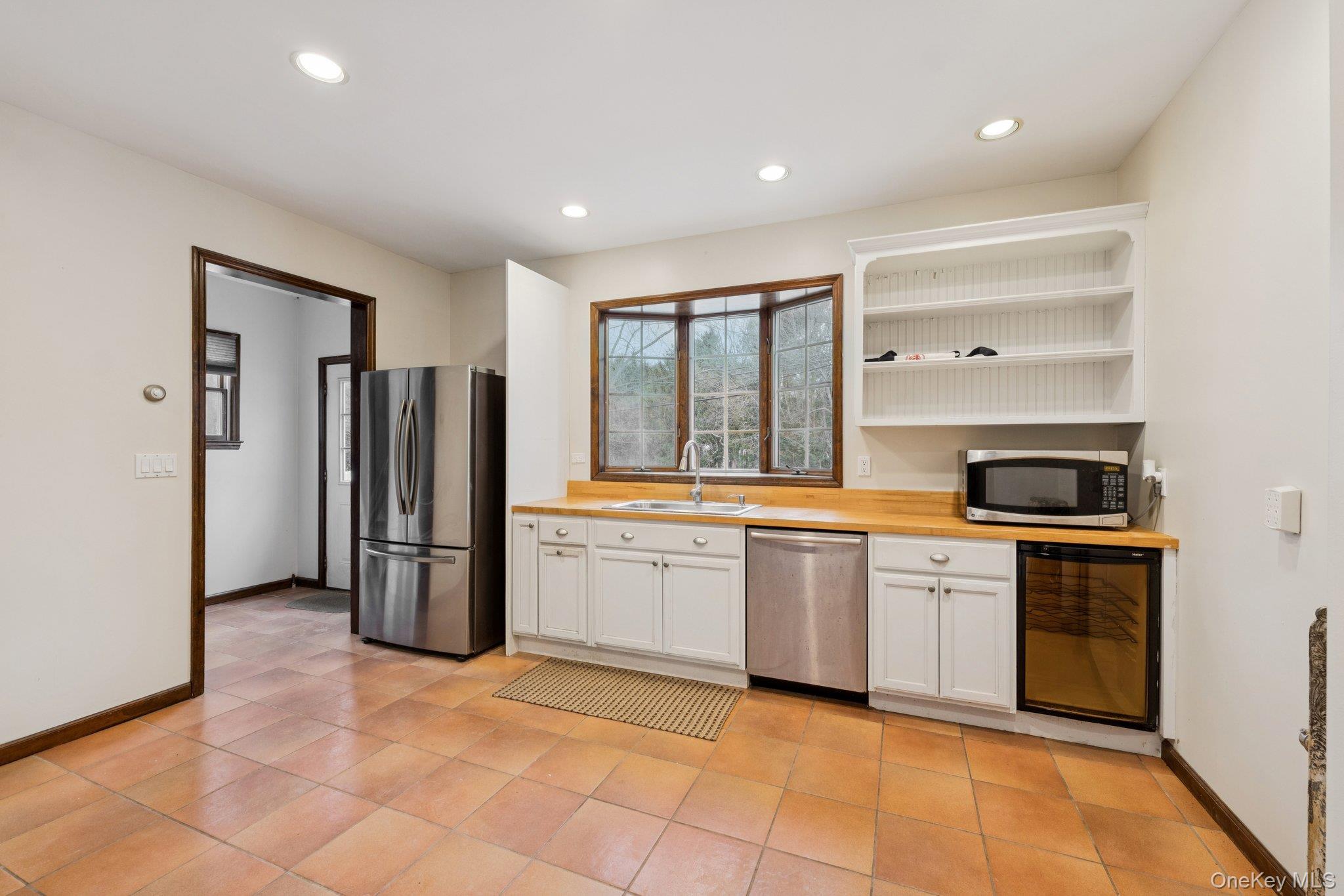 397 Split Rock Road Syosset, NY 11791 - Photo 14 of 29 a large kitchen with stainless steel appliances granite countertop a refrigerator and a sink