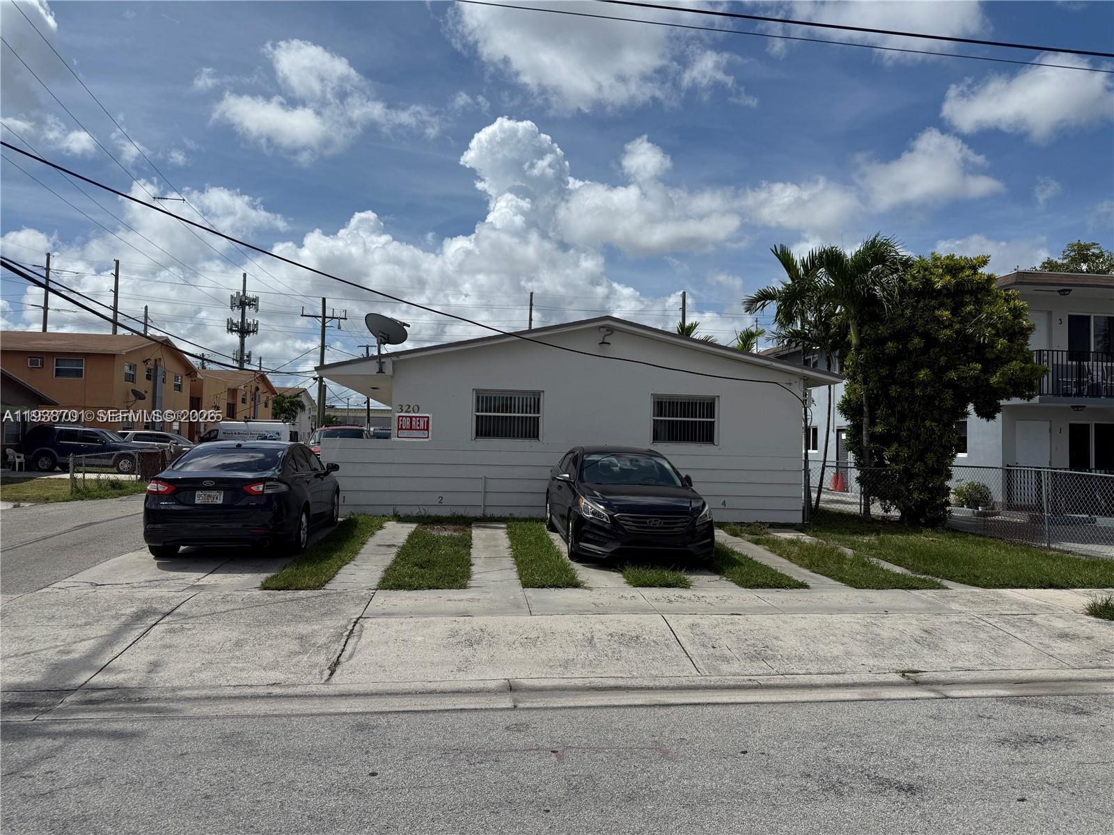 320 West 10th Street, Unit 4 Hialeah, FL 33010 - Photo 1 of 1 a view of a car parked front of a house