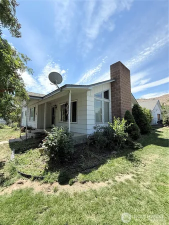 a front view of house with yard and green space
