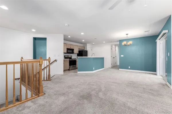 a kitchen with stainless steel appliances granite countertop a refrigerator a sink a stove with white cabinets