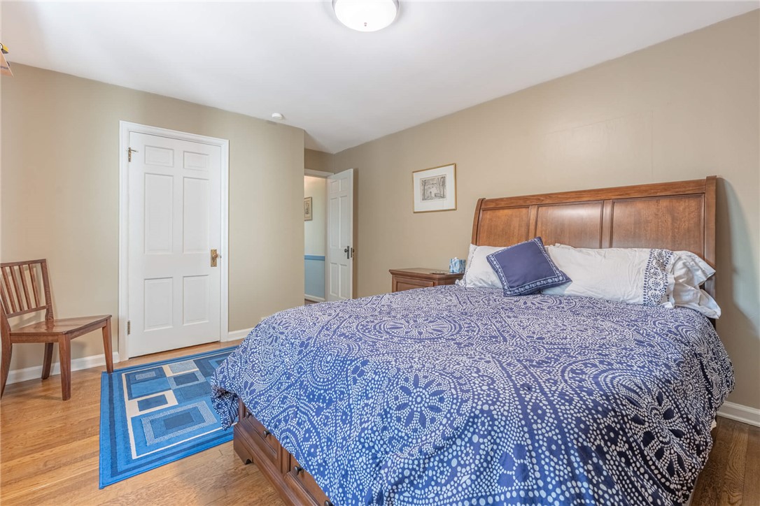 156 West Hadley Road Dayton, OH 45419 - Photo 24 of 71 This inviting bedroom features rich hardwood flooring and classic paneled doors, creating a warm and traditional atmosphere.