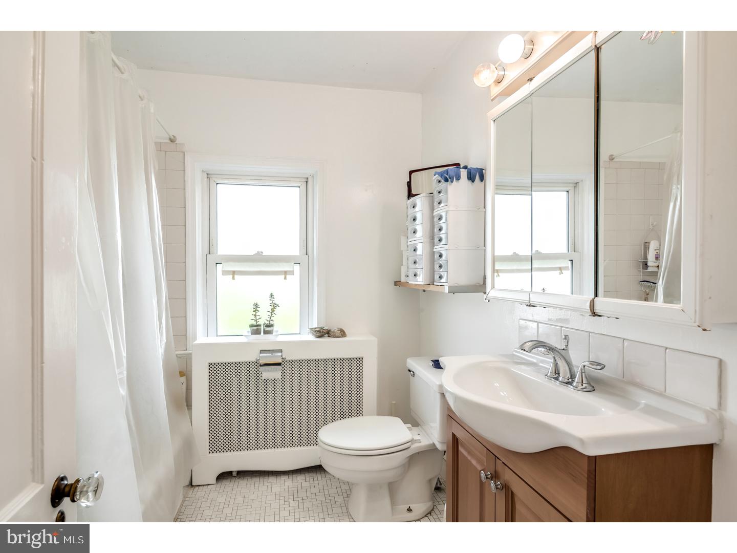 213 Clements Bridge Road Barrington, NJ 08007 - Photo 21 of 25 a bathroom with a sink a toilet and a mirror