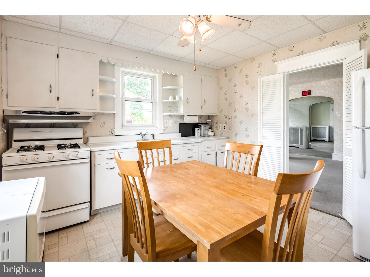 213 Clements Bridge Road Barrington, NJ 08007 - Photo 9 of 25 a kitchen with stainless steel appliances kitchen island granite countertop a stove a sink a dining table and chairs