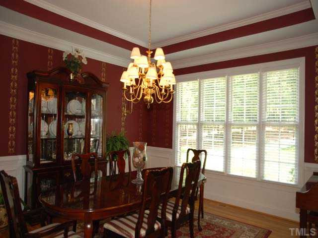 1005 Farnsworth Road Wake Forest, NC 27587 - Photo 5 of 25 The impressive dining room has gorgeous moldings and trey ceilings, a lovely chandelier, beautiful windows offering lots of natural light, and lovely hardwood floors. Dining Room